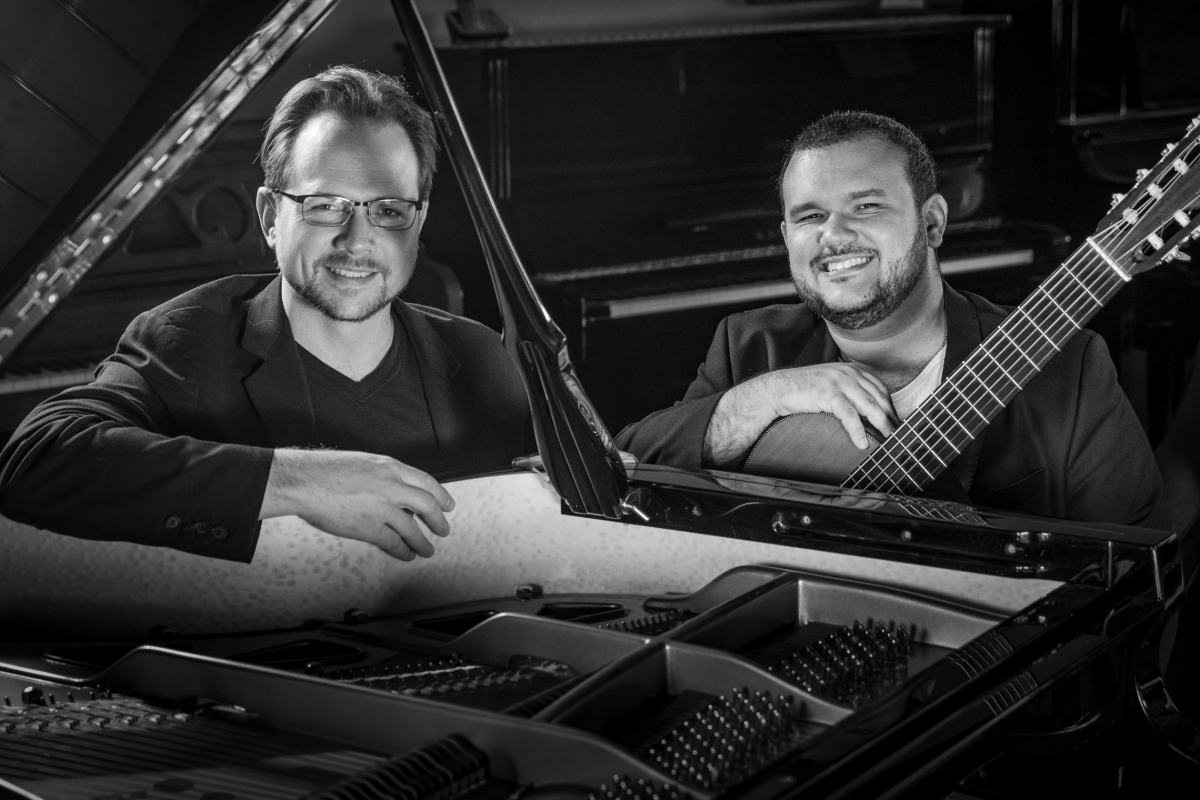 Man with guitar and man at piano