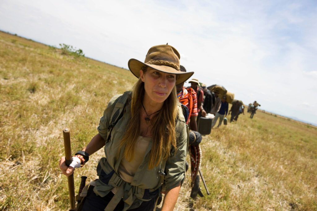 women hiking in a field